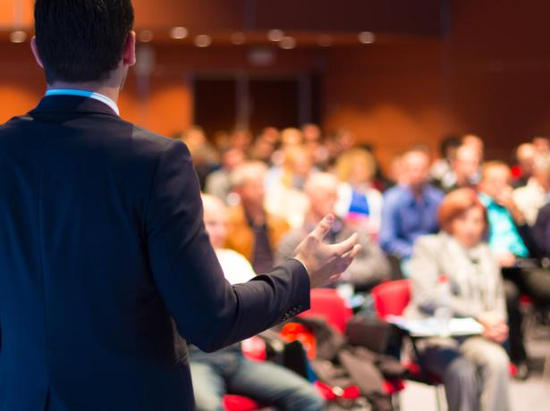 A speaker gives a presentation to an attentive audience.